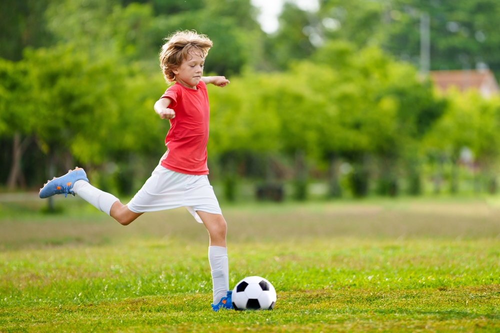 child playing soccer.